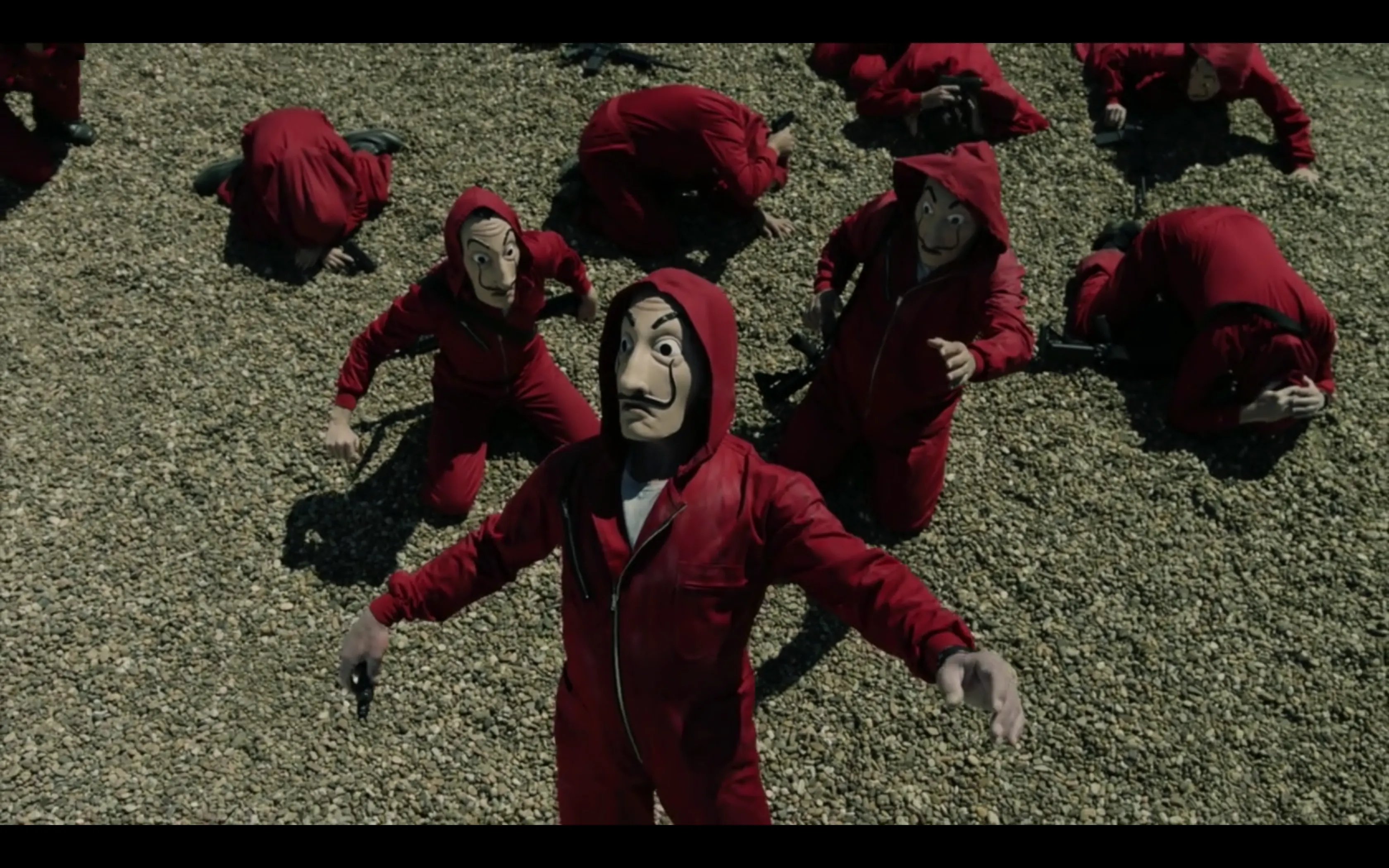 people with masks and red uniforms on the ground